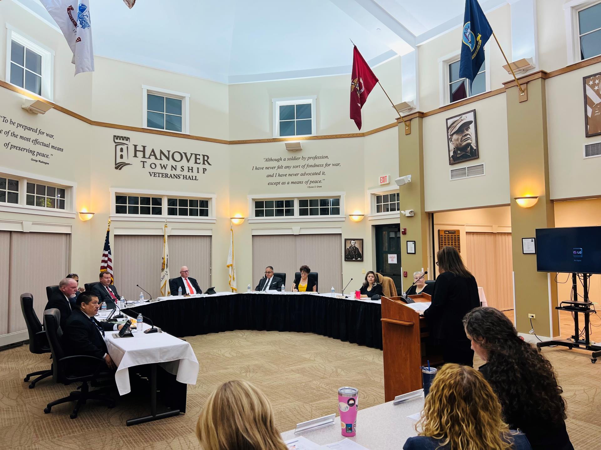 The elected officials sitting at the dais facing members in the audience during a board meeting.