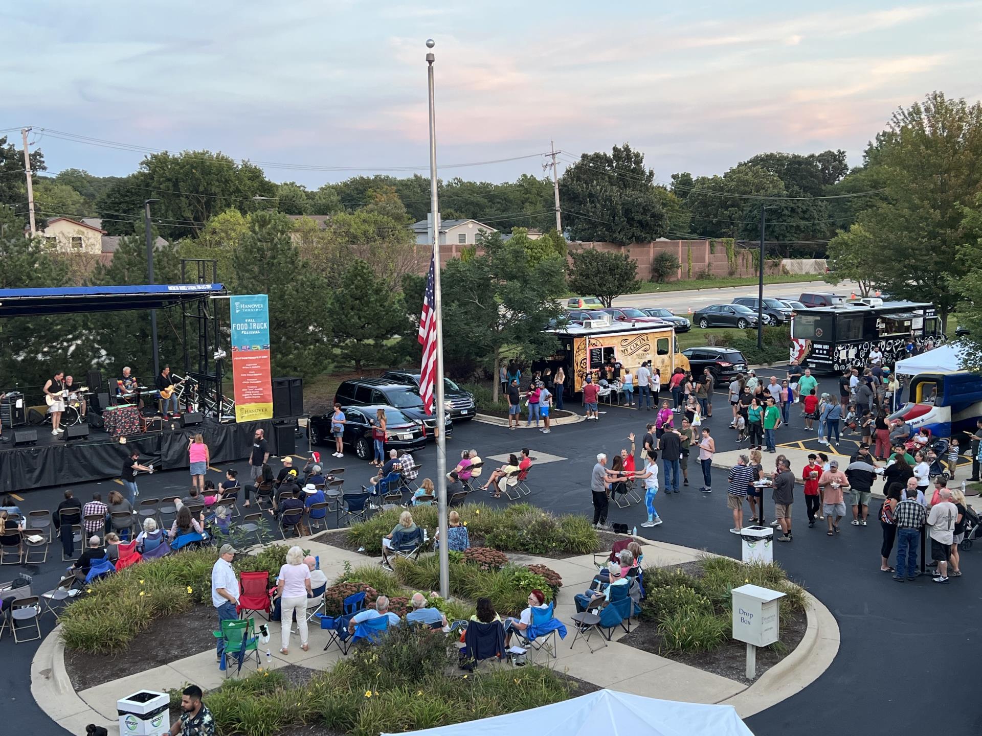 Overhead view of the Fall Food Truck Festival crowded with attendees, music on stage and food trucks