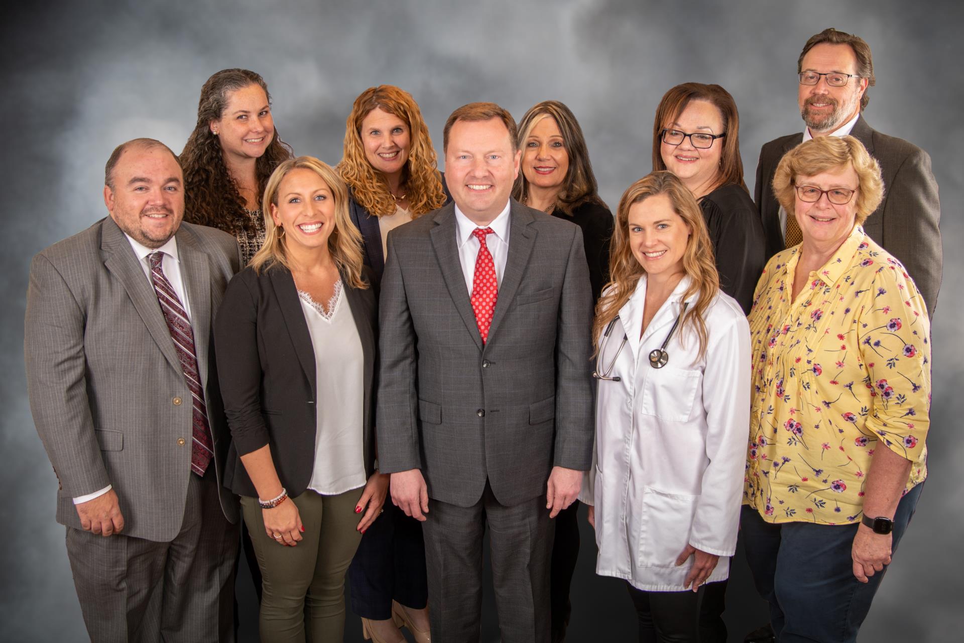 Hanover Township Department Heads, male and female, looks sharp and standing for a formal group photo in front of grey backdrop